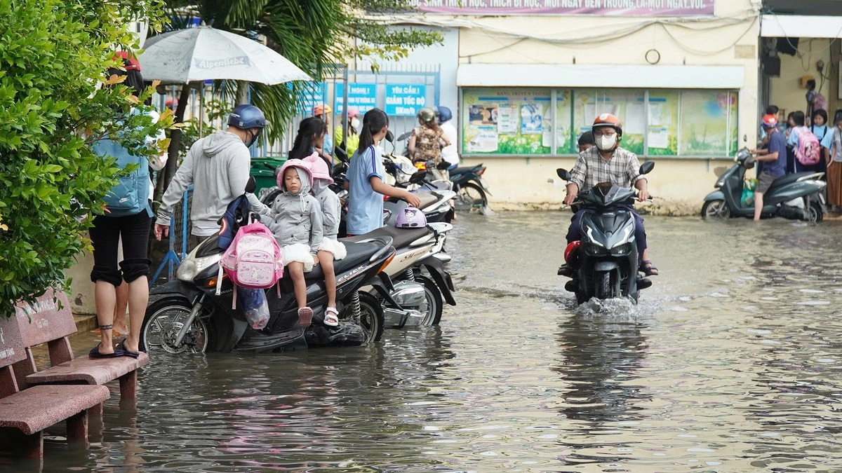 Trường ngập sau mưa lớn, phụ huynh bế con vào lớp